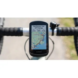Garmin bike computer mounted on handlebars displaying the Rum Runners Trail GPX package map and route details